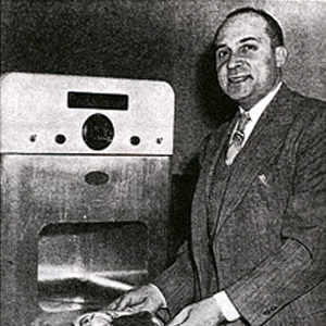Image of inventor stood next to the first microwave