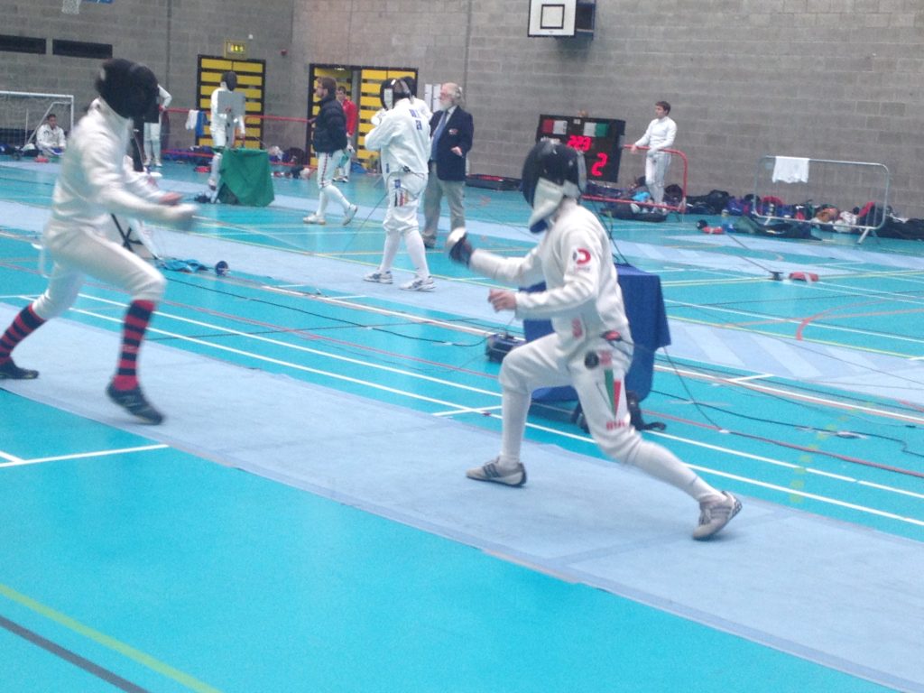 Men fencing in Domex branded kit in London sports hall