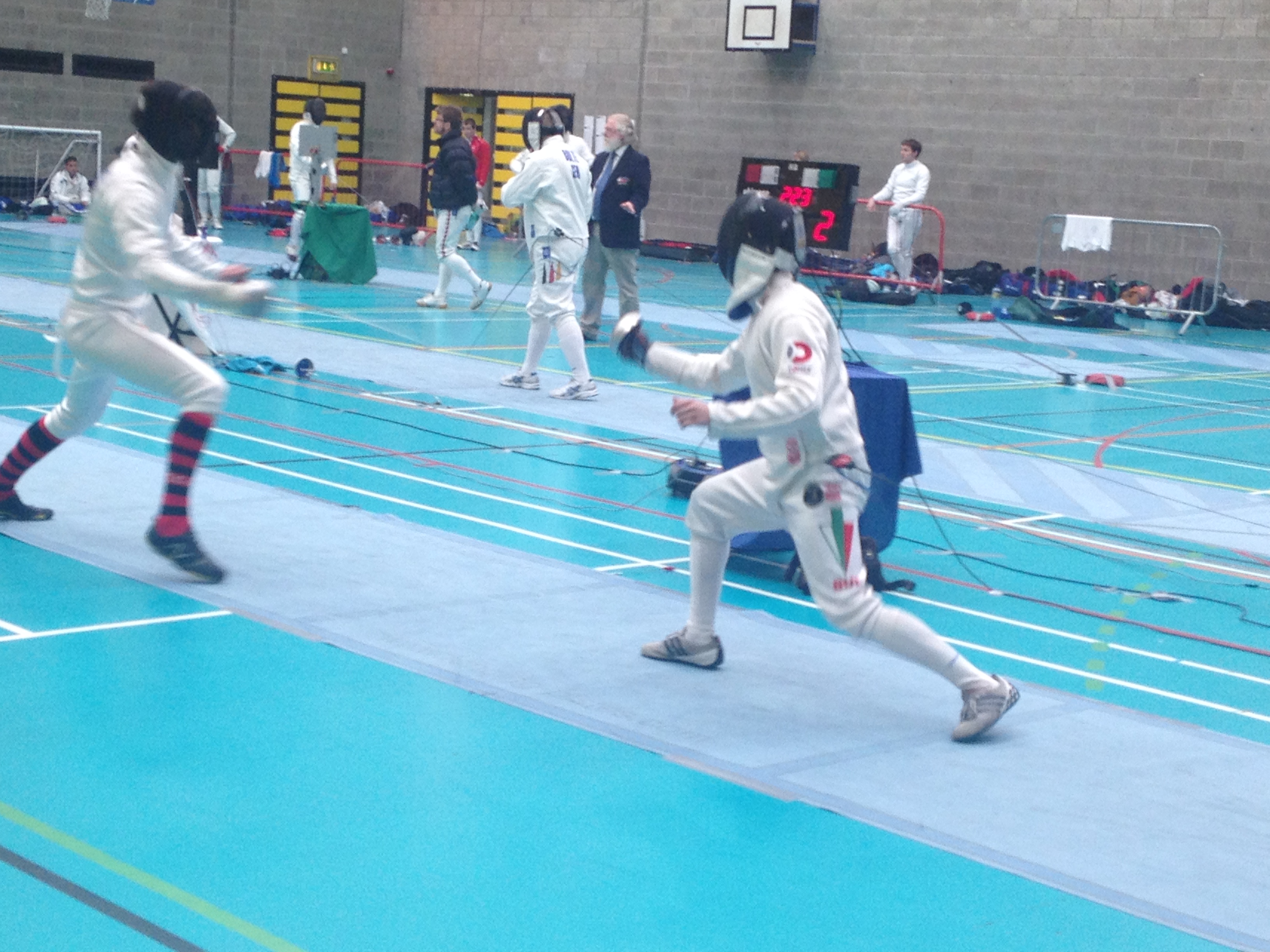 Men fencing in Domex branded kit in London sports hall