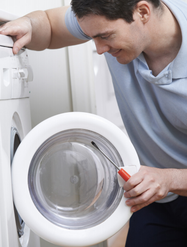 Man fixing washing machine door that won't close