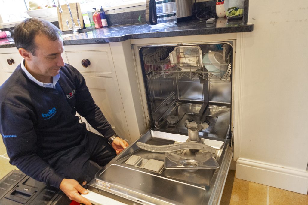 Domex Ltd engineer repairing dishwasher